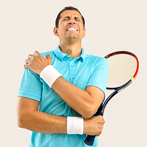 photograph showing a male tennis player holding his shoulder in pain.
